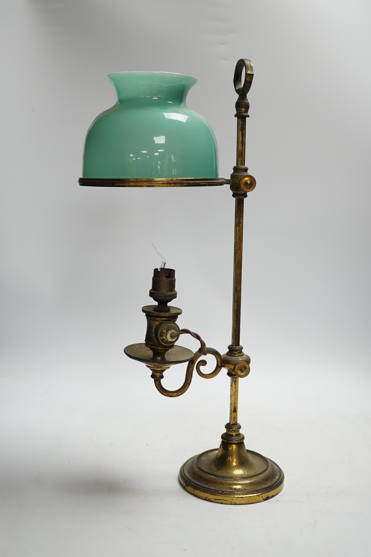 A brass desk lamp with green glass shade, circa 1920’s